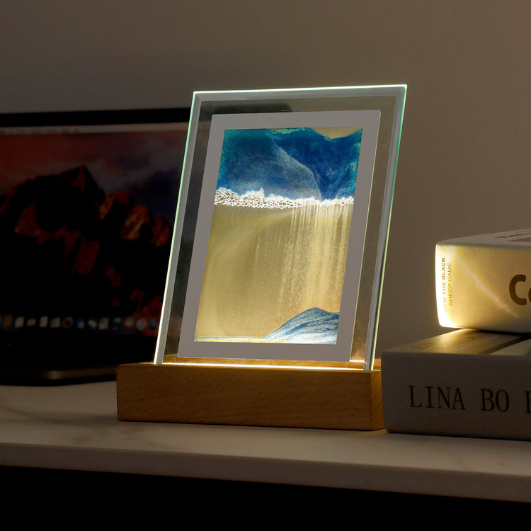 Moving Sand Art LED Lamp in Blue on a bedside table